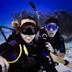 Divers pulling their tongues on the PADI Open Water Course in Cancun