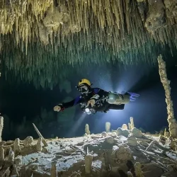 Cave diving under cenote stalagmites from Costa Mujeres