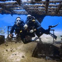 Two scuba divers explore the C55 Gereral Anaya wreck from Costa Mujeres