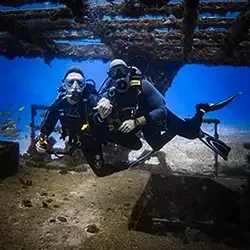Two scuba divers explore the C55 Gereral Anaya wreck from Costa Mujeres